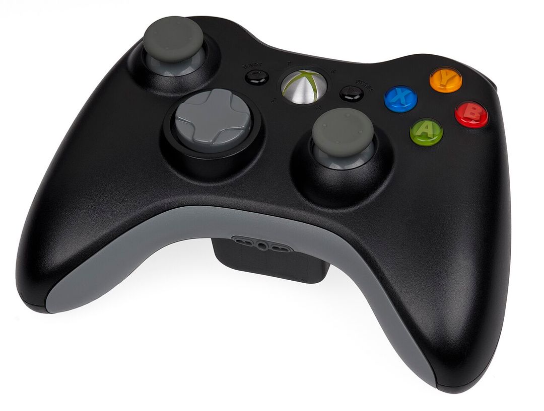 Manette sans fil noire de Xbox 360 sur fond blanc.